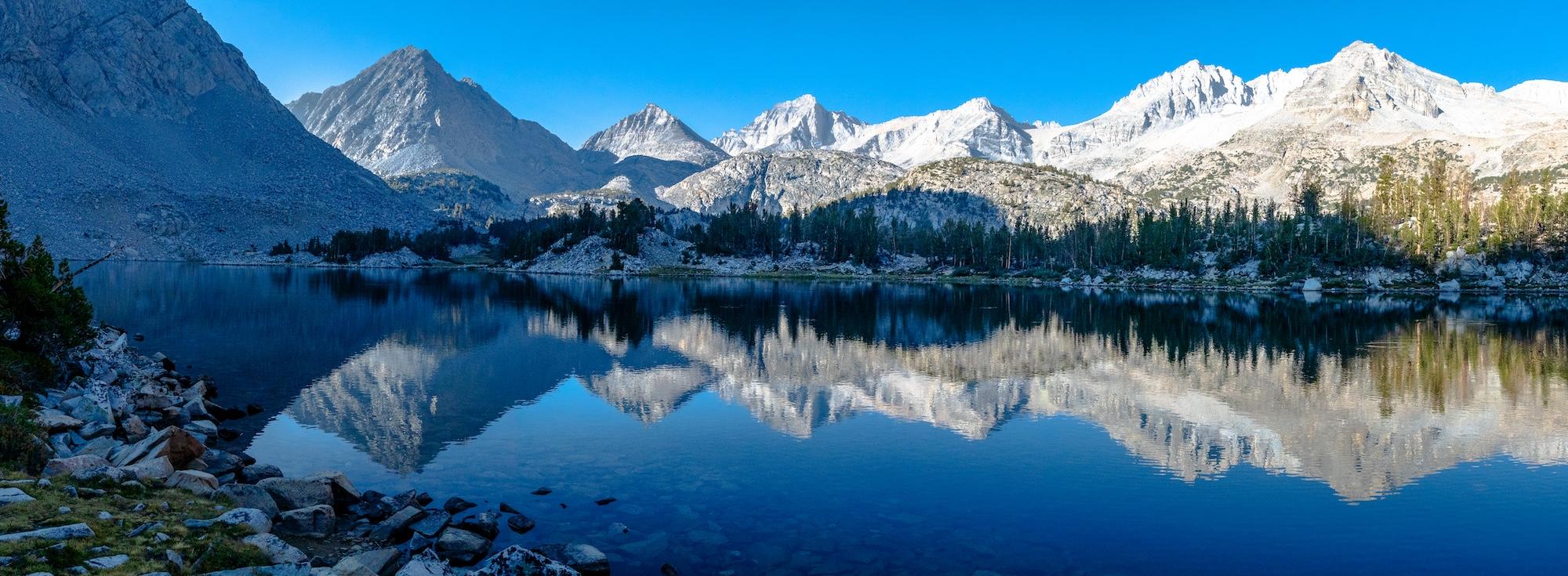 Panorama of a mountain reflection at Chickenfoot Lake in The Little Lakes Valley of the Sierras. Photo by Brock Dallman