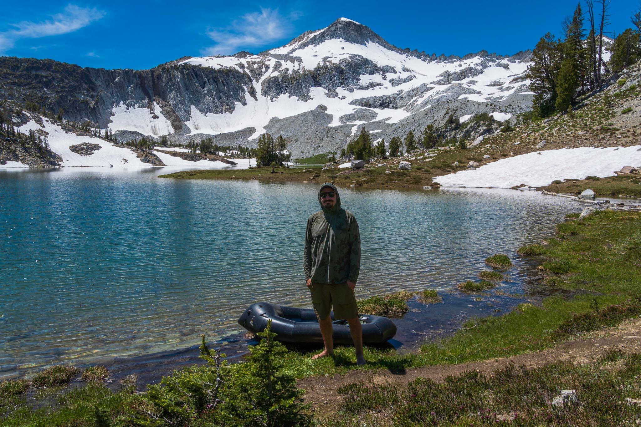 Brock with a packraft at Glacier Lake in the Eagle Cap wilderness