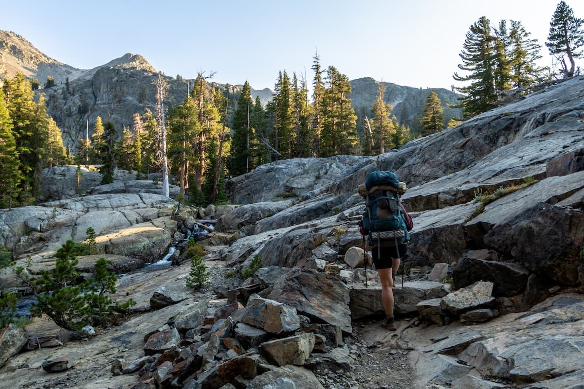 Sam Stych hiking a rocky trail