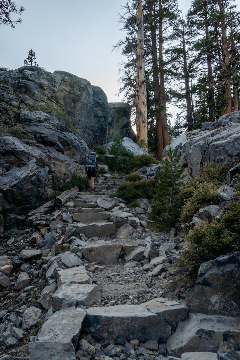 Sam Stych climbing a rocky staircase towards Ediza Lake