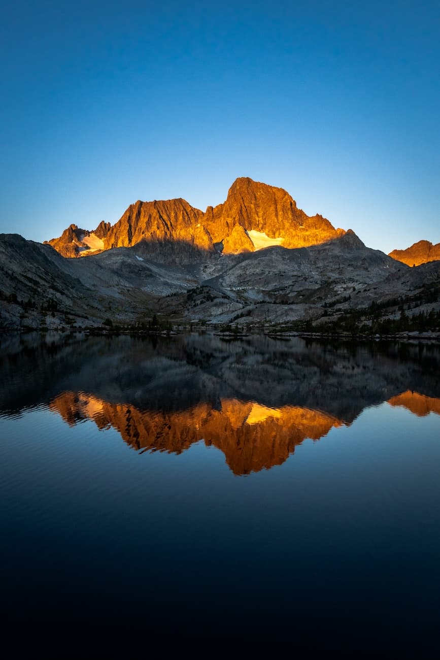Morning sun shining on Banner Peak over Garnet Lake