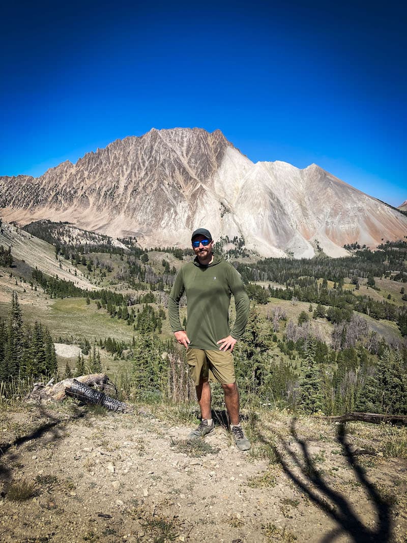 Brock Dallman with Castle Peak and the Chamberlain Basin in the background