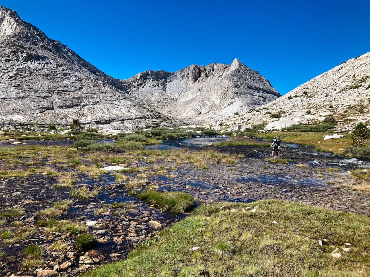 Sam Stych Crossing a Mountain Creek in the Sierras