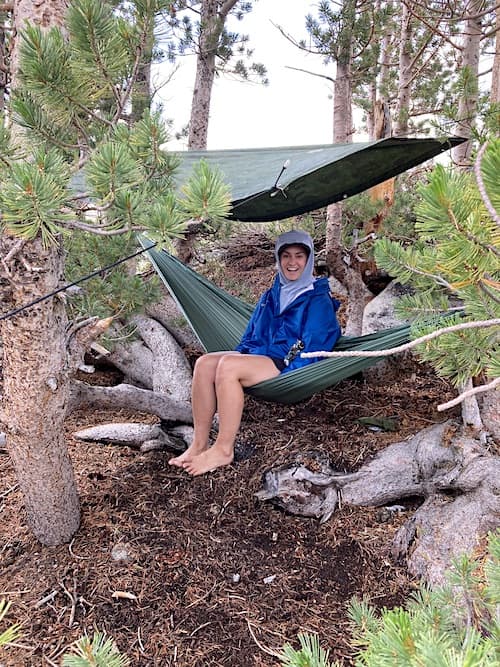 Sam Stych weathering the storm under a tarp